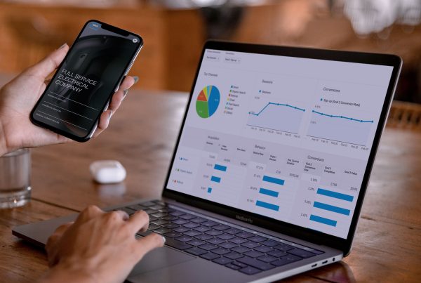 Business owner reviewing website performance metrics and analytics on a laptop screen